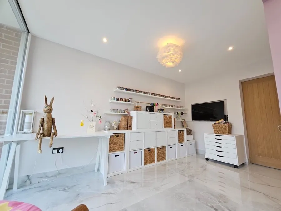 White-painted room with fitted shelving and storage