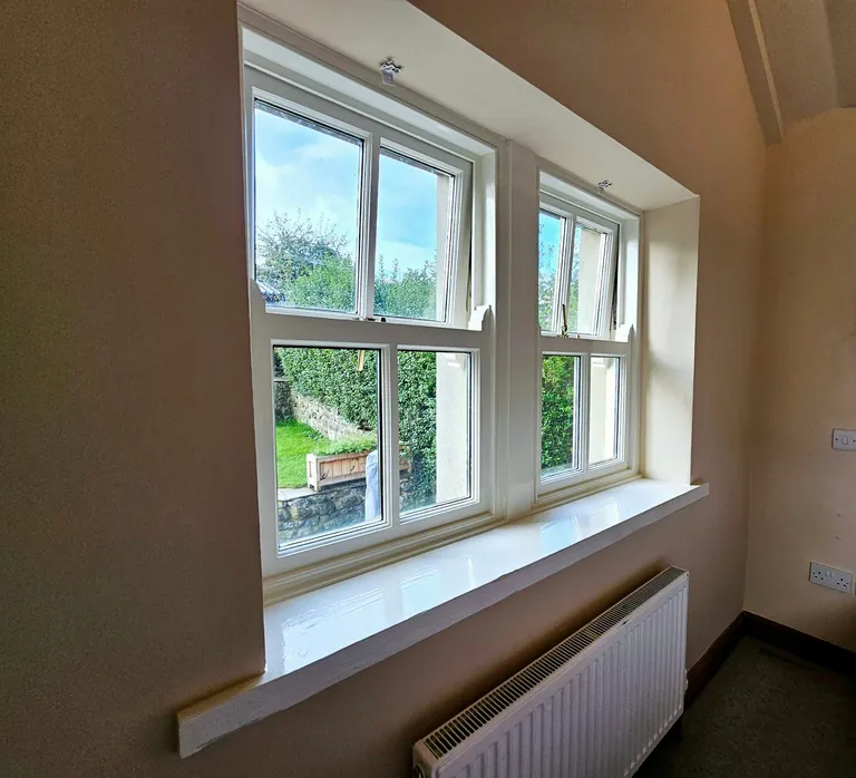 White-painted window frame and sill against warm neutral walls