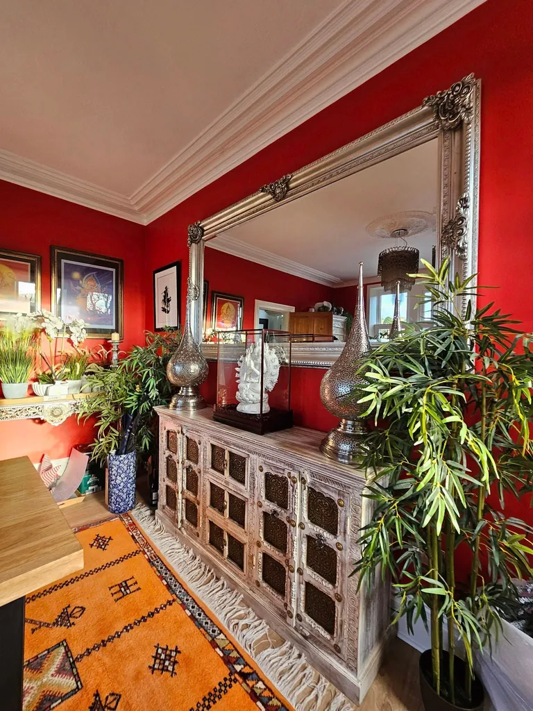 Dining room with red painted walls and white cornice
